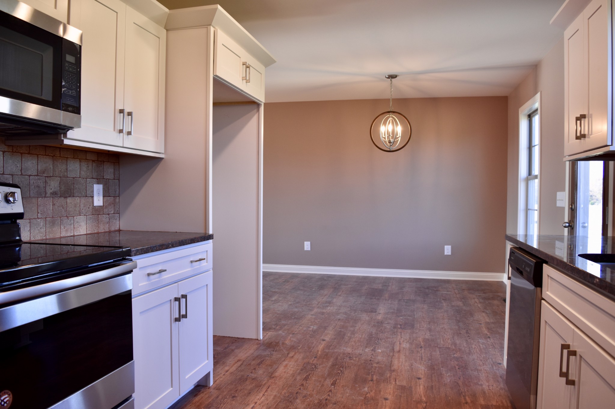 151 East Carter Road Portland, TN 37148 - Photo 7 of 14 a kitchen with granite countertop a stove a microwave and cabinets