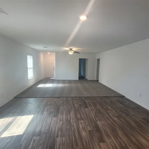 a view of a room with wooden floors and fireplace