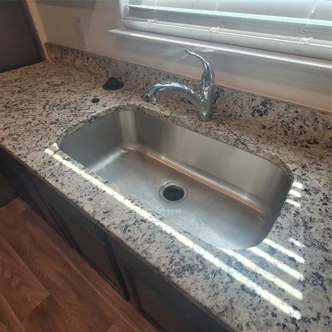 a view of kitchen with sink and microwave
