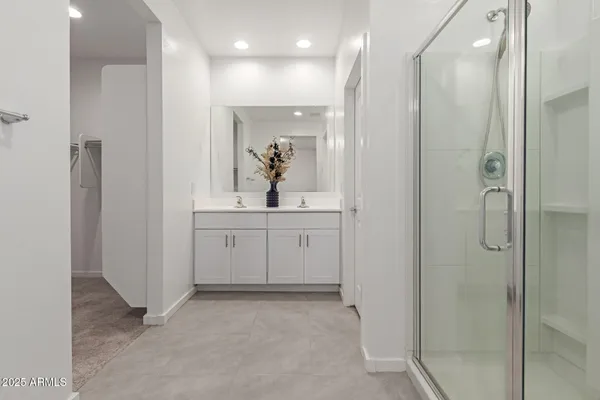 a bathroom with a shower sink and mirror