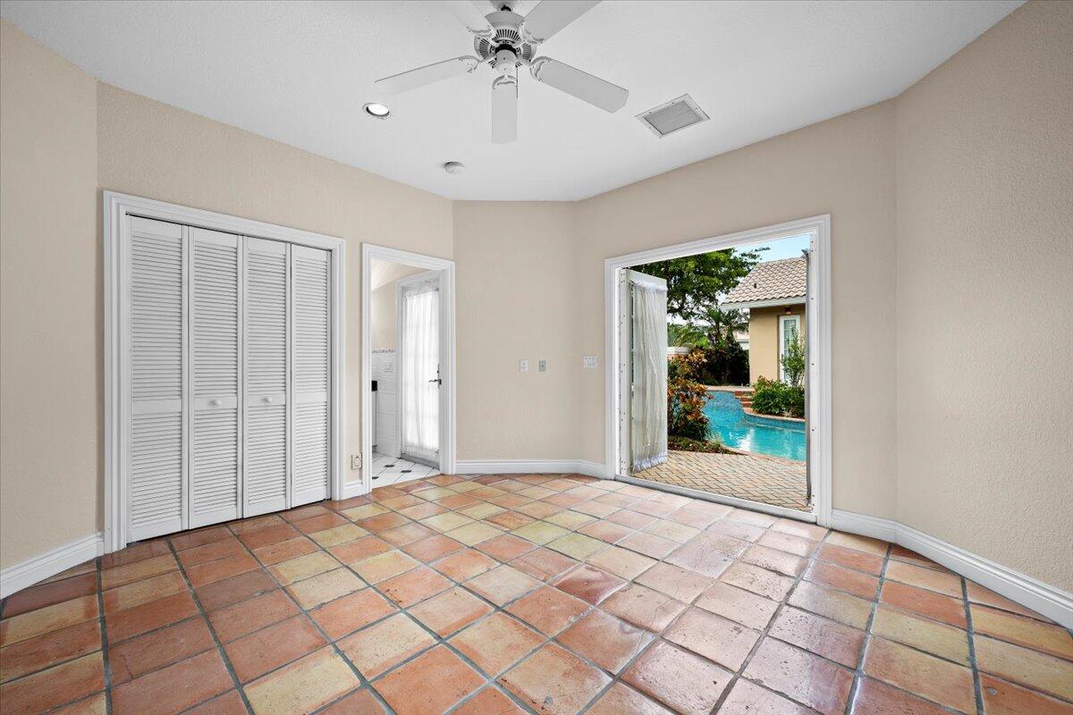 3241 Northwest 63rd Street Boca Raton, FL 33496 - Photo 11 of 75 a view of a room with a chandelier fan and windows