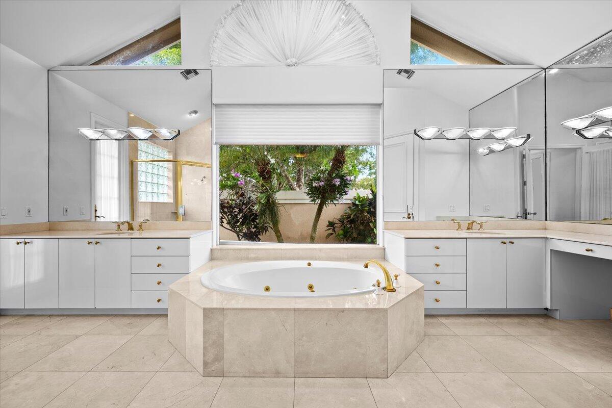 3241 Northwest 63rd Street Boca Raton, FL 33496 - Photo 38 of 75 a bathroom with a bathtub a sink and a large window