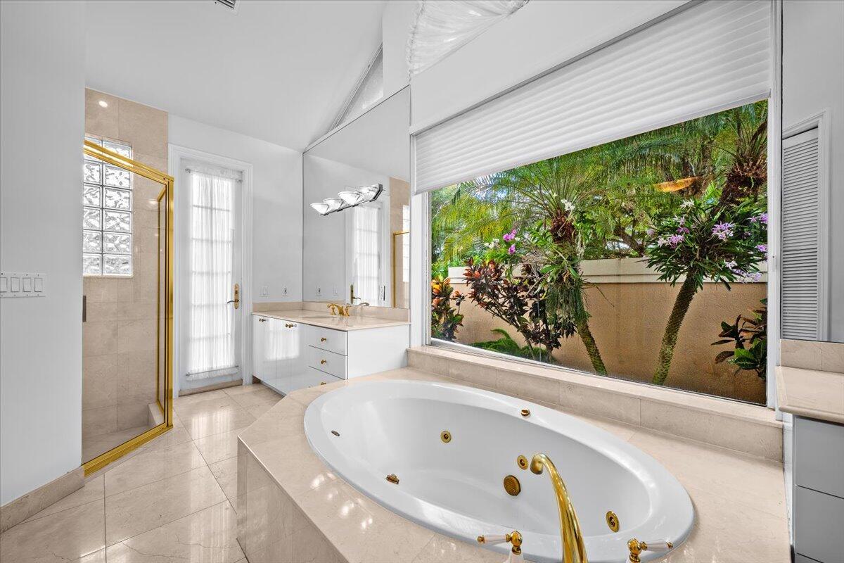 3241 Northwest 63rd Street Boca Raton, FL 33496 - Photo 39 of 75 a bathroom with a bathtub and a large window