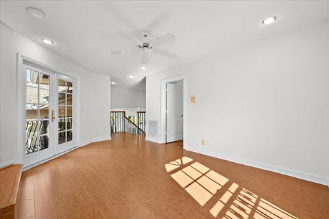 an aerial view of residential houses with outdoor space and trees