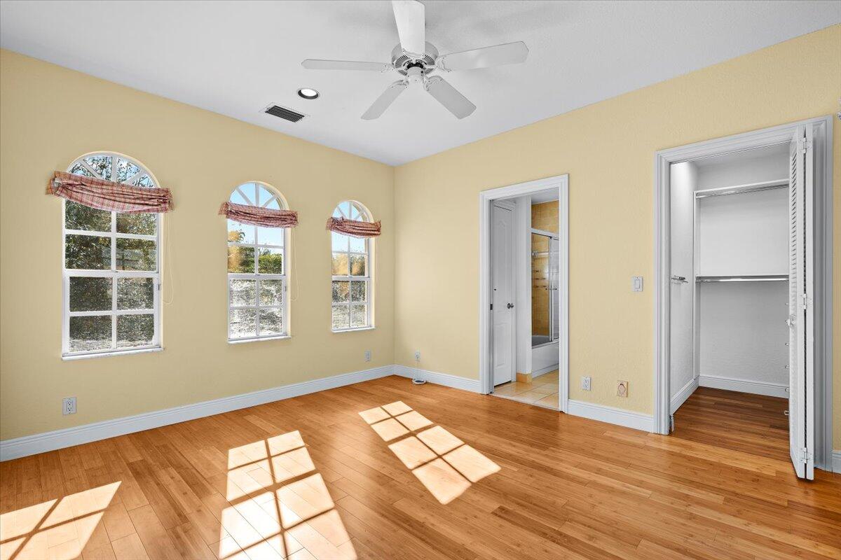 3241 Northwest 63rd Street Boca Raton, FL 33496 - Photo 46 of 75 a view of an empty room with window and wooden floor