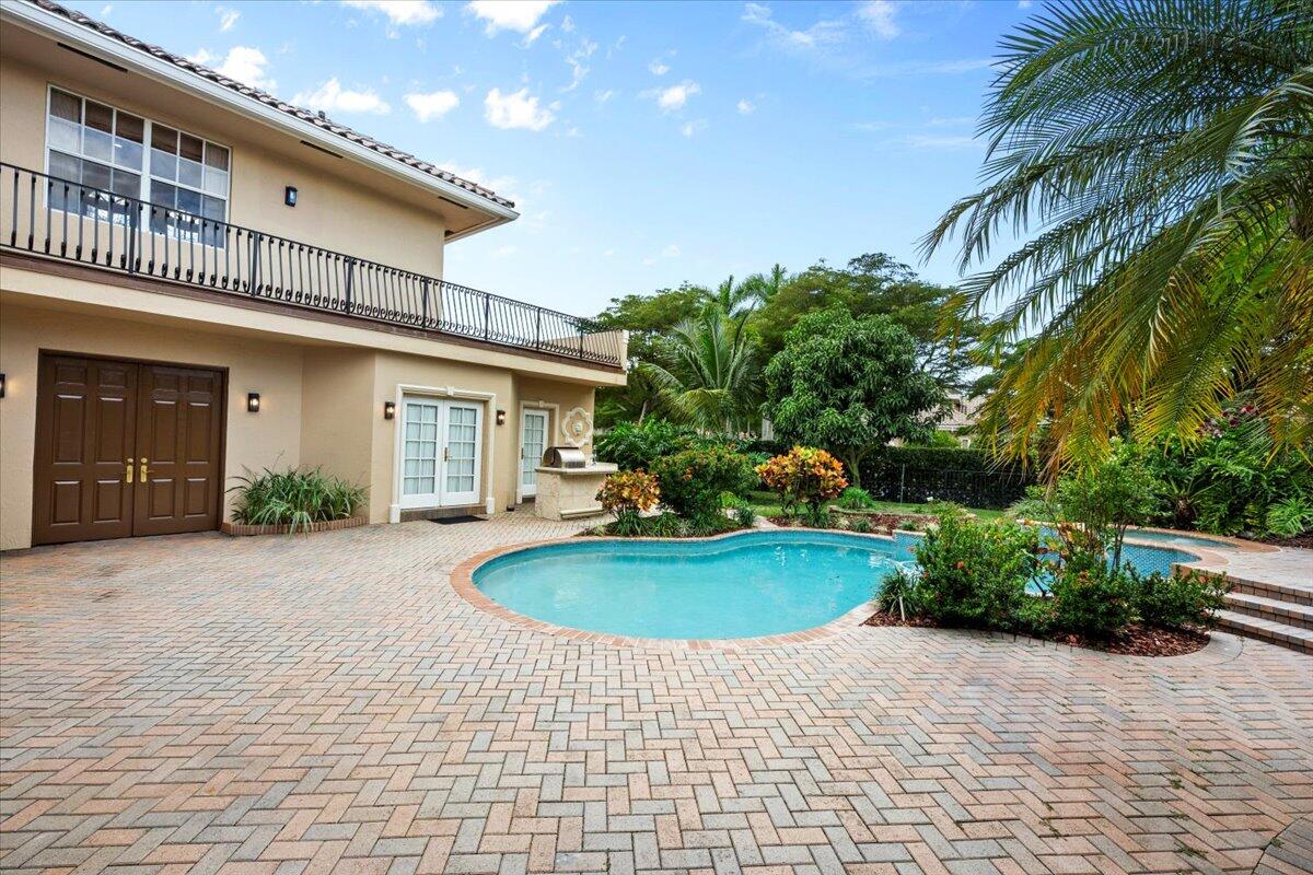 3241 Northwest 63rd Street Boca Raton, FL 33496 - Photo 56 of 75 a front view of a house with a yard