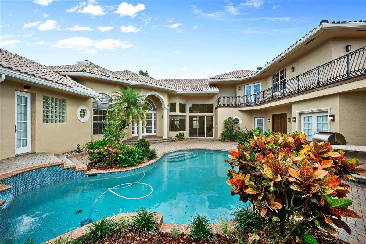 3241 Northwest 63rd Street Boca Raton, FL 33496 - Photo 59 of 75 front view of a house with a big yard