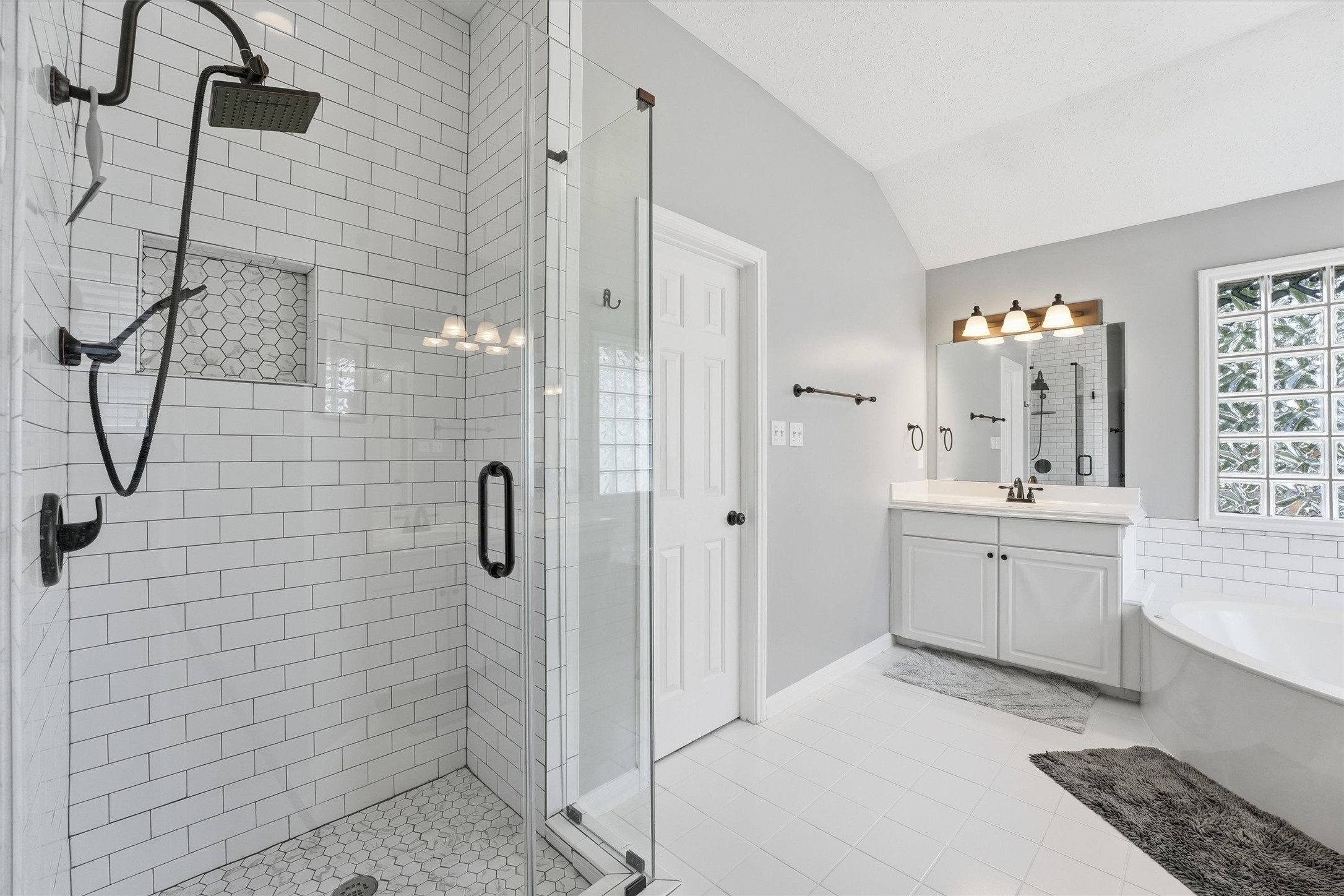 8827 Mile Run Road Humble, TX 77346 - Photo 20 of 37 a bathroom with a double sink shower and a mirror