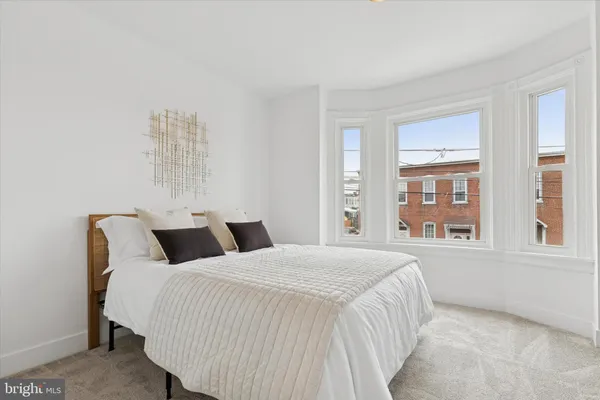 a bedroom with bed and a window