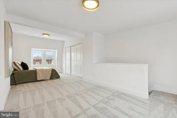 a spacious bedroom with a bed and couch