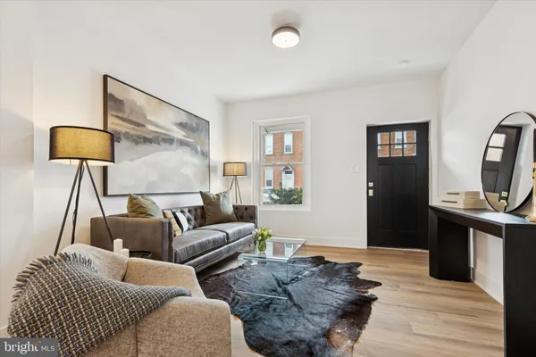 a living room with furniture and a lamp