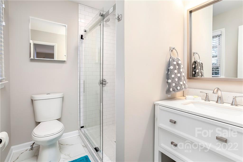 6009 Pepperhill Road Charlotte, NC 28212 - Photo 14 of 17 a bathroom with a toilet sink vanity and shower
