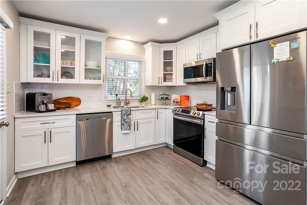6009 Pepperhill Road Charlotte, NC 28212 - Photo 4 of 17 a kitchen with stainless steel appliances a refrigerator sink and cabinets