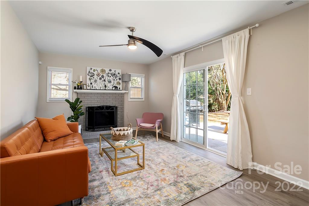 6009 Pepperhill Road Charlotte, NC 28212 - Photo 7 of 17 a living room with furniture a rug and a fireplace