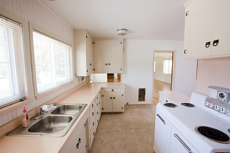1710 Barbara Road Redding, CA 96003 - Photo 9 of 23 a kitchen that has a lot of white cabinets and wooden floor