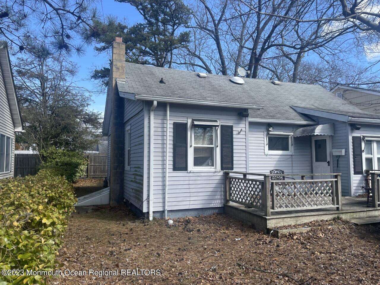 691 Mantoloking Road Brick, NJ 08723 - Photo 2 of 16 a view of a house with a small yard and wooden fence