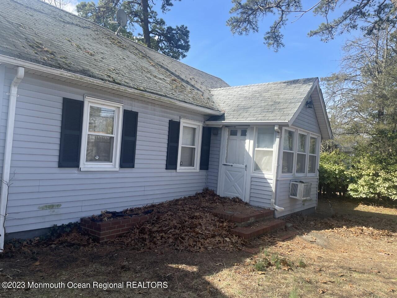 691 Mantoloking Road Brick, NJ 08723 - Photo 3 of 16 a front view of a house with a yard