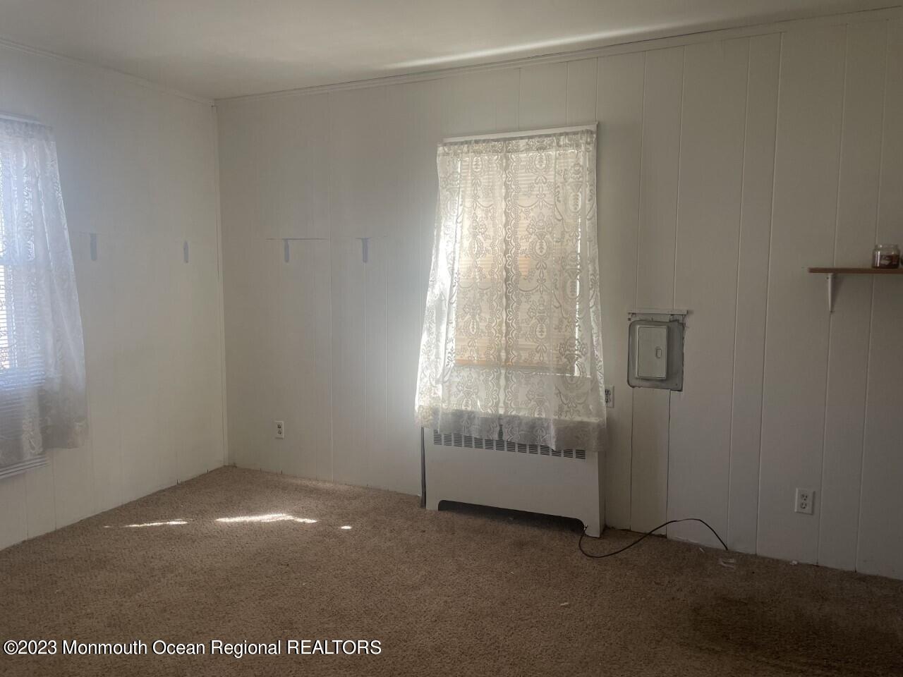 691 Mantoloking Road Brick, NJ 08723 - Photo 8 of 16 a view of empty room with window