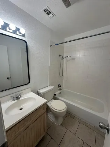 a bathroom with a double vanity sink toilet mirror and shower