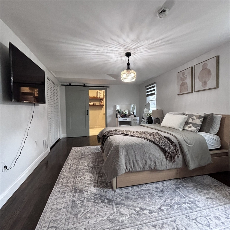 20 Morgan Road Holbrook, MA 02343 - Photo 16 of 21 a spacious bedroom with a bed and a flat screen tv