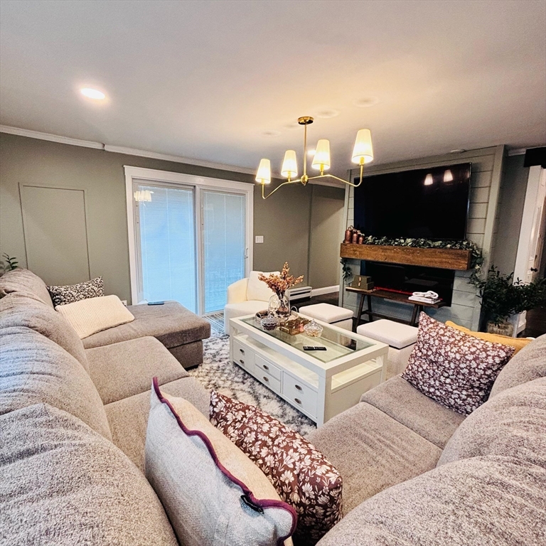 20 Morgan Road Holbrook, MA 02343 - Photo 5 of 21 a living room with furniture a flat screen tv and a fireplace