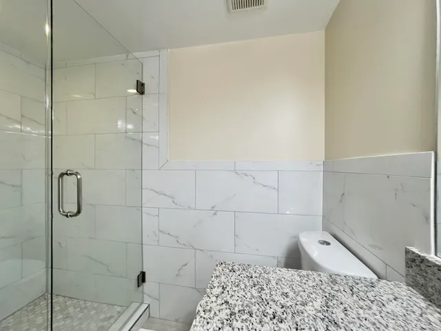 a bedroom with two beds and a flat screen tv