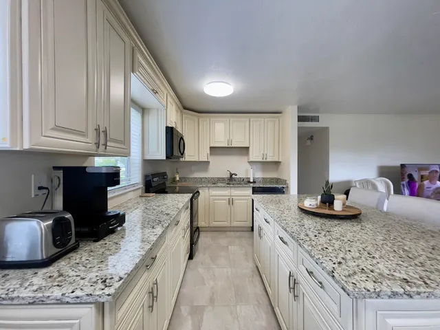 a large kitchen with granite countertop lots of counter top space