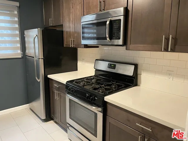 a kitchen with a stove microwave and refrigerator