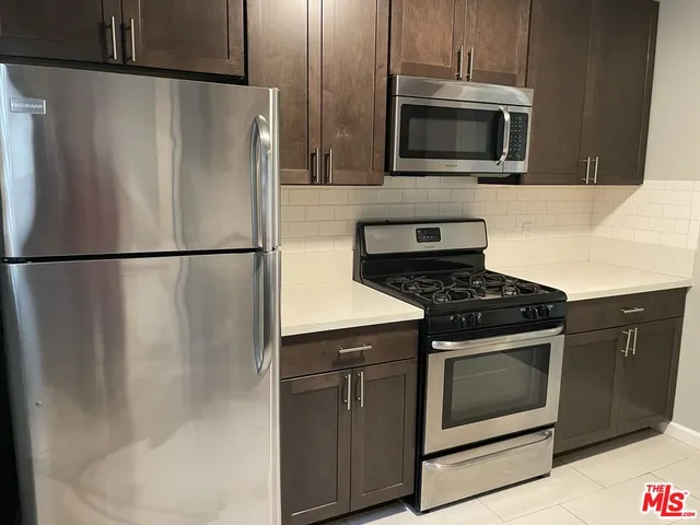 a kitchen with cabinets and steel stainless steel appliances