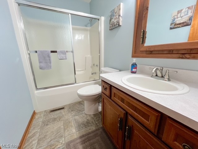 1349 Deer Hill Road Dennison, OH 44621 - Photo 25 of 36 Full bathroom with vanity, tile patterned flooring, shower / bath combination with glass door, and toilet