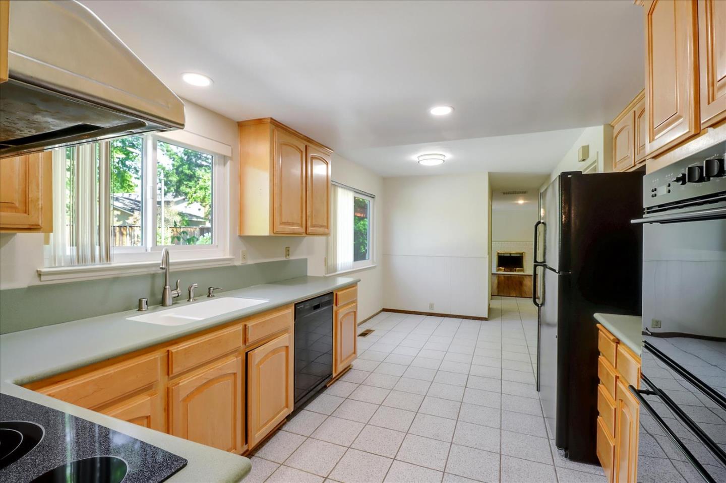 6908 Burnside Drive San Jose, CA 95120 - Photo 13 of 37 a kitchen with stainless steel appliances granite countertop a sink stove and refrigerator