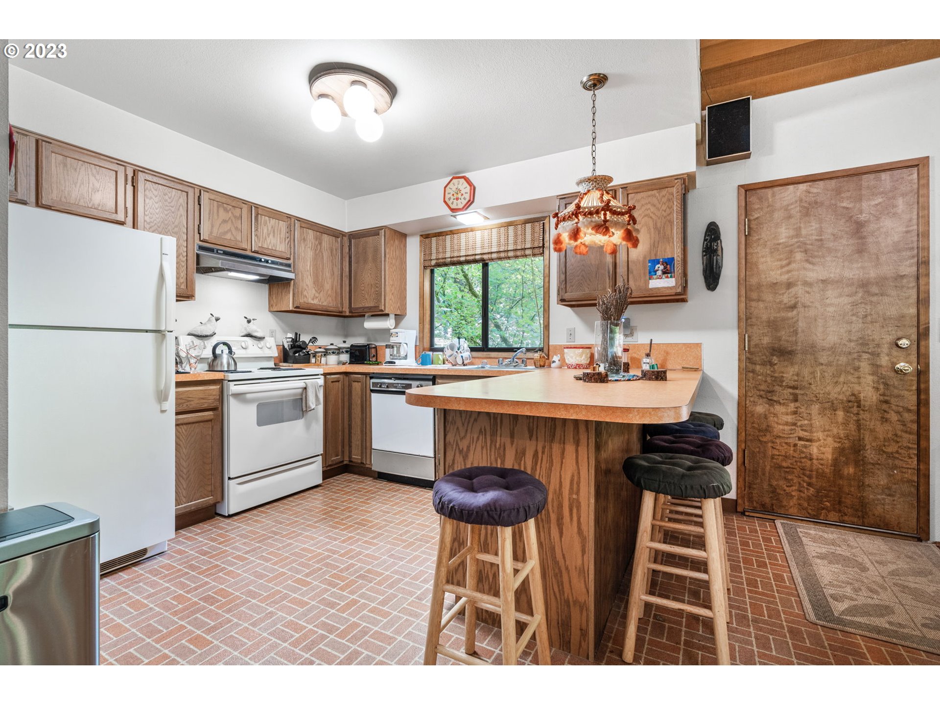 65582 East Timberline Drive Rhododendron, OR 97049 - Photo 12 of 48 a kitchen with stainless steel appliances a table chairs and a refrigerator