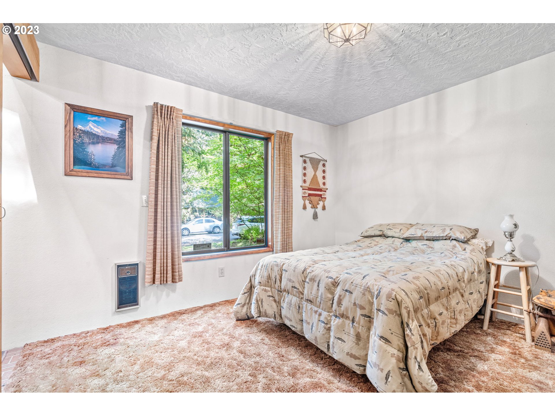 65582 East Timberline Drive Rhododendron, OR 97049 - Photo 16 of 48 a bedroom with a bed lamp and a large window