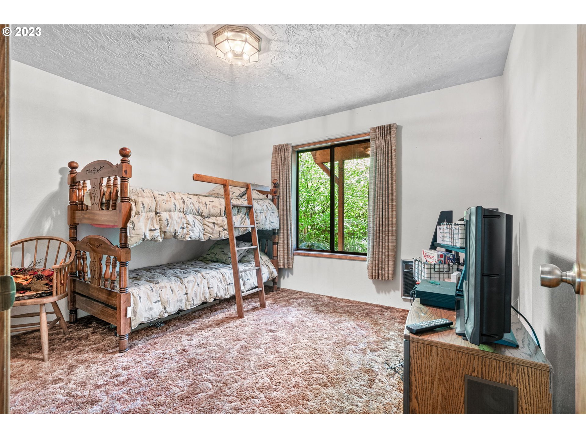 65582 East Timberline Drive Rhododendron, OR 97049 - Photo 18 of 48 a bedroom with furniture and a flat screen tv