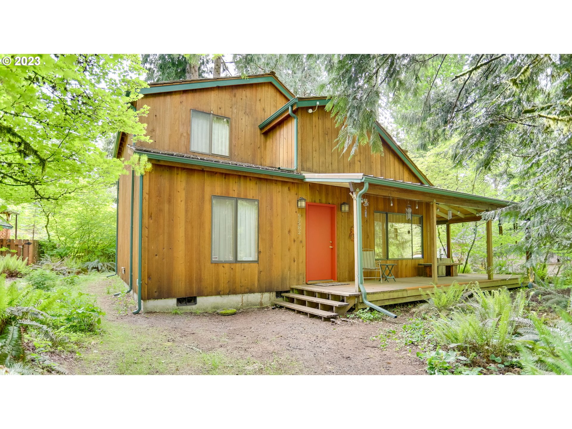 65582 East Timberline Drive Rhododendron, OR 97049 - Photo 2 of 48 a backyard of a house with lots of green space