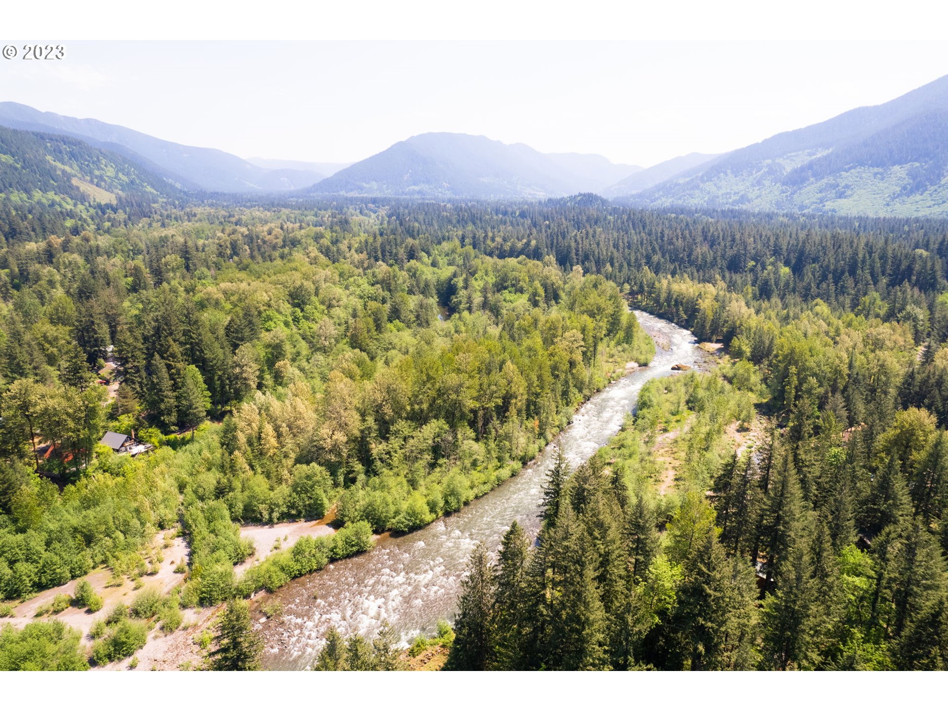 65582 East Timberline Drive Rhododendron, OR 97049 - Photo 35 of 48 a view of a lush green hillside and a houses