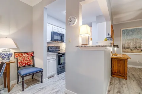 a kitchen with stainless steel appliances granite countertop a stove and a refrigerator