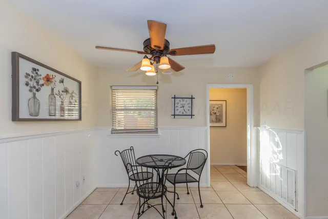 a dining room with furniture and window