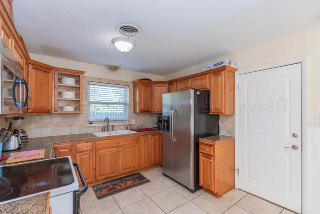 a kitchen with stainless steel appliances a refrigerator and a sink