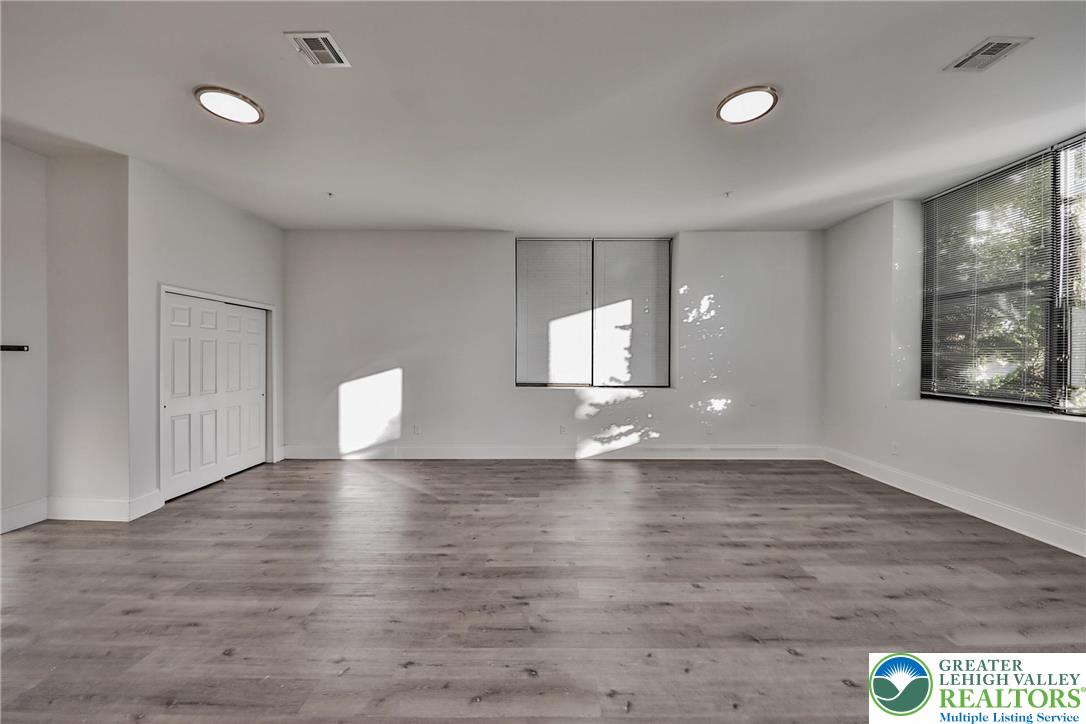 10 West Goepp Street, Unit 207 Bethlehem, PA 18018 - Photo 12 of 24 a view of an empty room with window and wooden floor