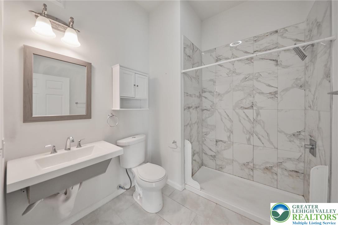 10 West Goepp Street, Unit 207 Bethlehem, PA 18018 - Photo 16 of 24 a bathroom with a sink a toilet and shower