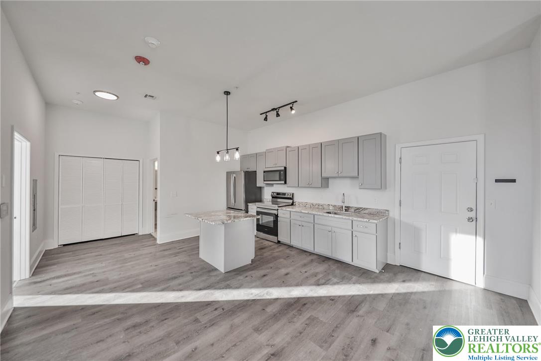 10 West Goepp Street, Unit 207 Bethlehem, PA 18018 - Photo 7 of 24 a kitchen with a sink dishwasher and a refrigerator