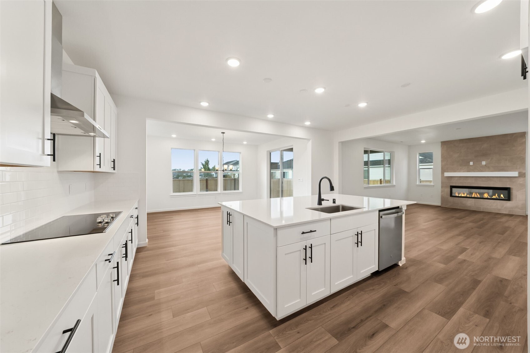 723 South Davis Street, Unit 103 Buckley, WA 98321 - Photo 5 of 13 a large white kitchen with stainless steel appliances granite countertop a lot of counter space and wooden floors