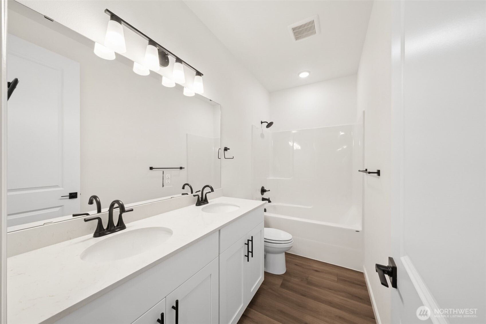 723 South Davis Street, Unit 103 Buckley, WA 98321 - Photo 10 of 13 a bathroom with a double vanity sink a toilet and a tub