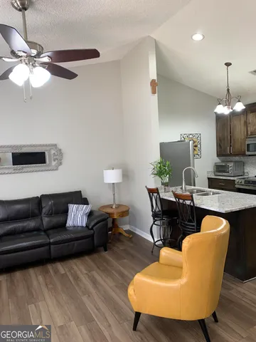 a living room with furniture and a chandelier