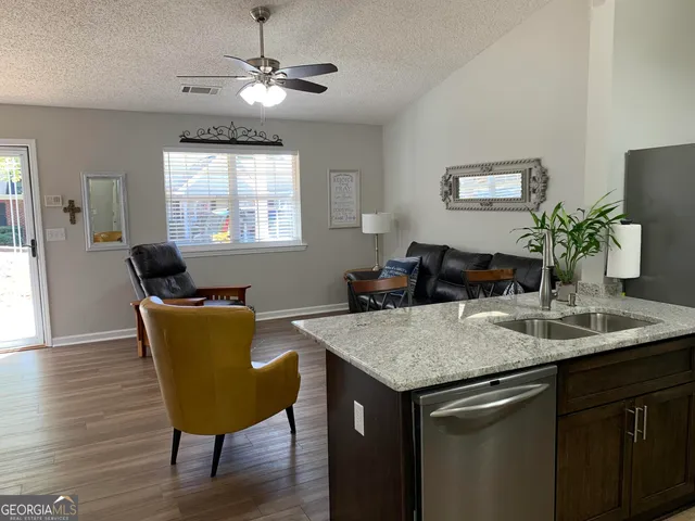a kitchen with a table chairs and wooden floor