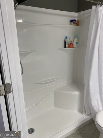 a bathroom with a bathtub and toilet