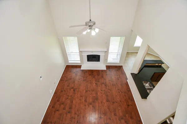 wooden floor in an empty room with a fireplace