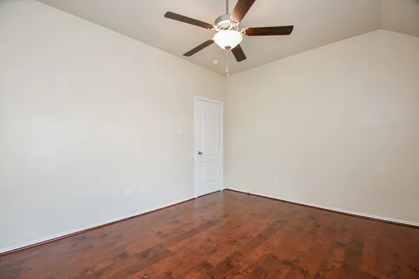 an empty room with a fan and a fan