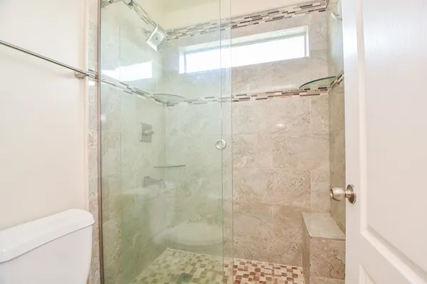 a bathroom with a glass shower door